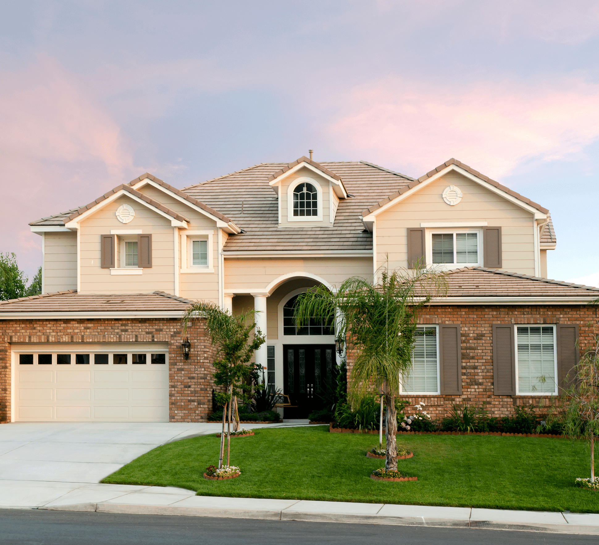 Two-story house with a manicured lawn.
