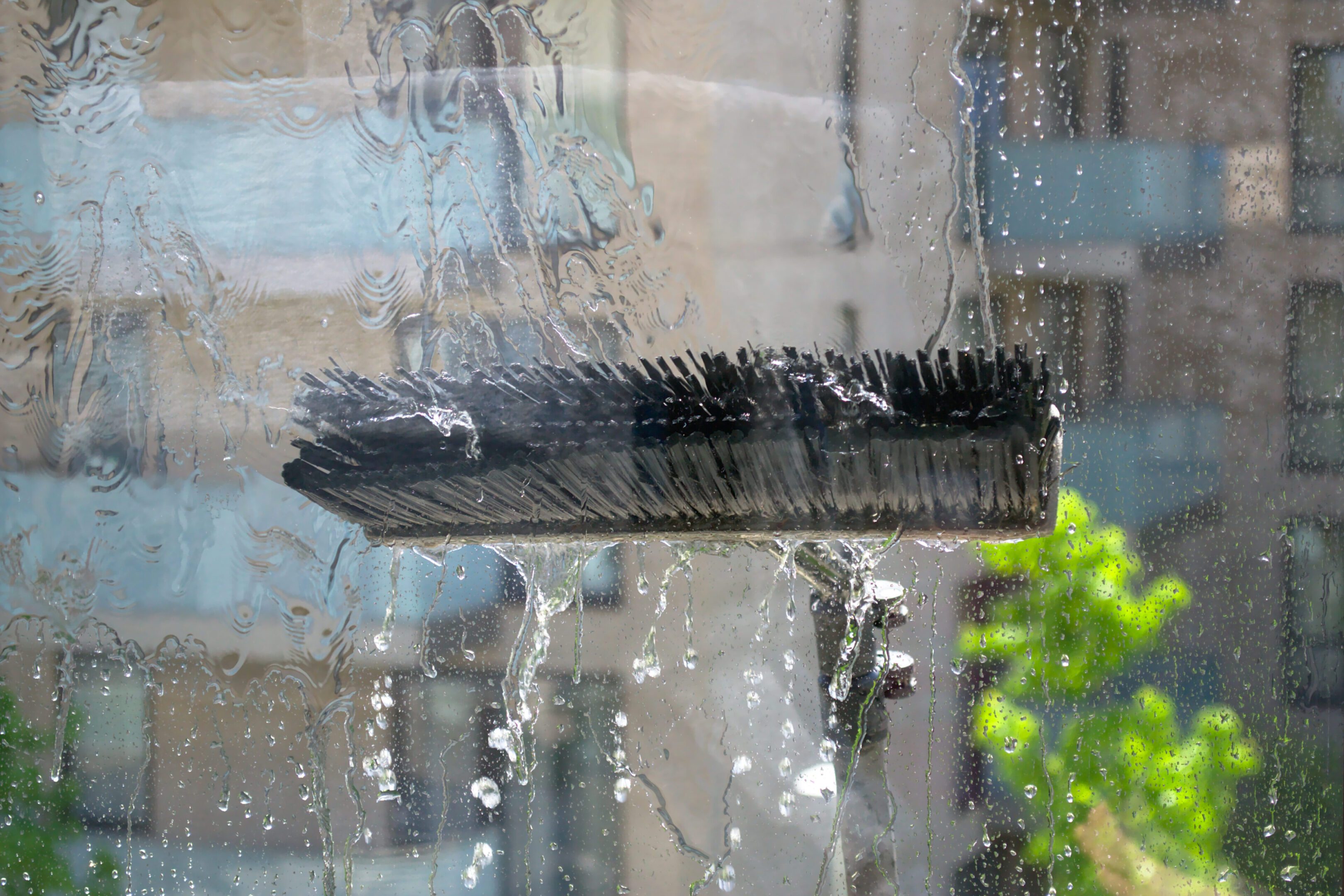 Window glass cleaning with pure water and extension pole. Washing and rinse using a reach and wash system. Window glass cleaning with pure water and extension pole. Washing and rinse using a reach and wash system.